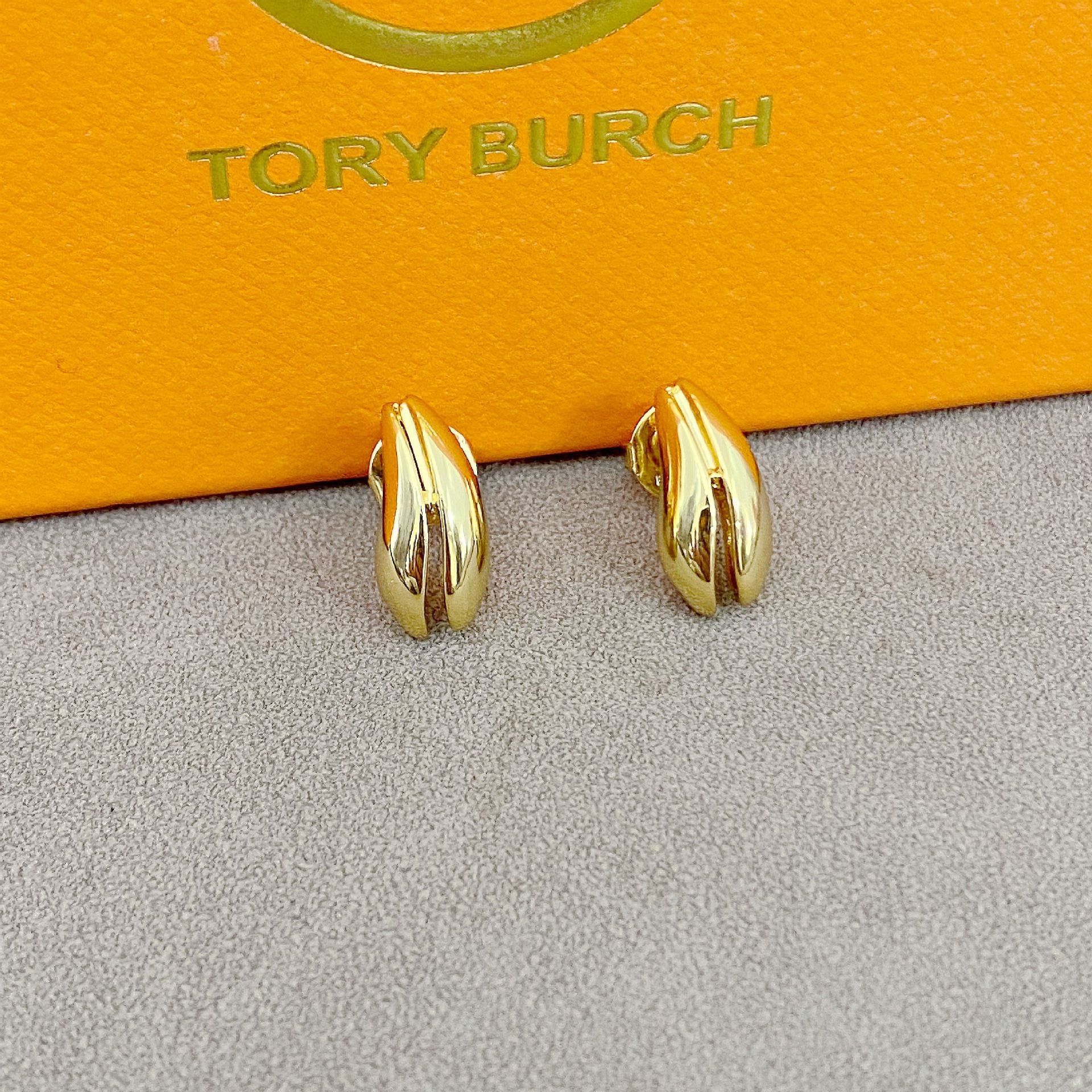 High-definition shot of the pair of earrings laid flat on pure white background, arranged symmetrically.