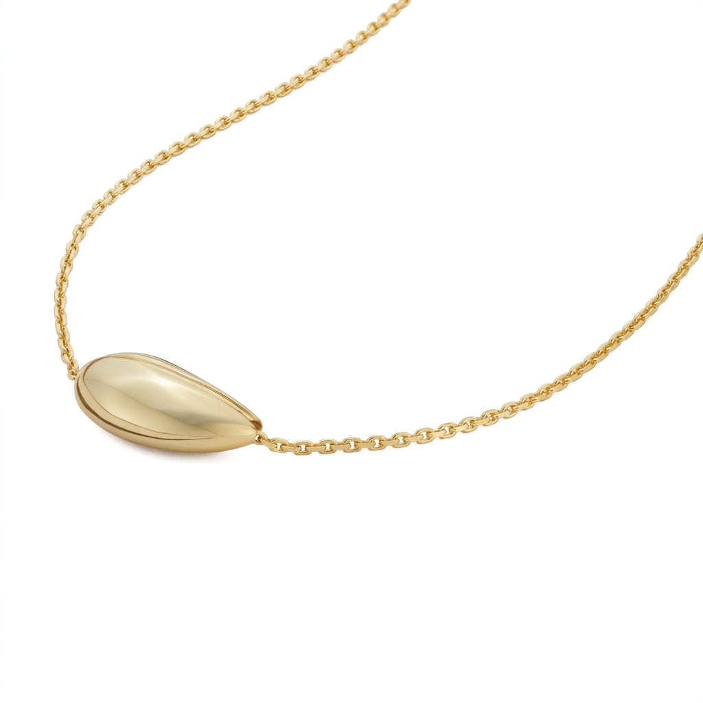 A gold teardrop pendant necklace on a delicate gold chain, shown against a plain white background.