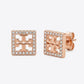 Rose gold square earrings with clear gemstones on a white background