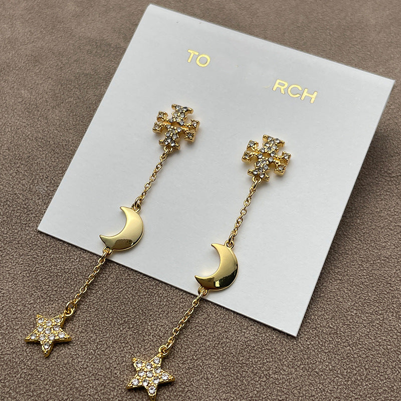 Both earrings displayed against a dark, navy blue or black velvet background to make the gold tone and crystal sparkle stand out dramatically.