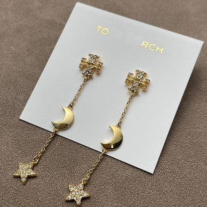 Both earrings displayed against a dark, navy blue or black velvet background to make the gold tone and crystal sparkle stand out dramatically.