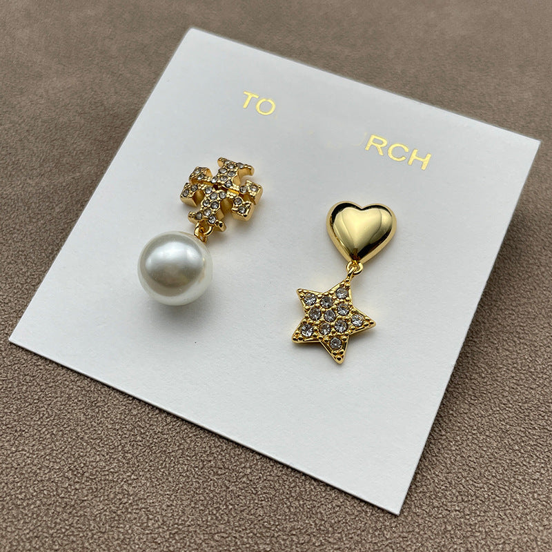 Both earrings displayed against a dark, navy blue or black velvet background to make the gold tone and crystal sparkle stand out dramatically.