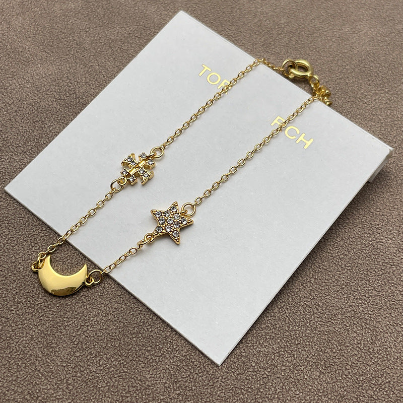 Both earrings displayed against a dark, navy blue or black velvet background to make the gold tone and crystal sparkle stand out dramatically.