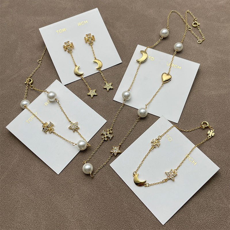 Both earrings displayed against a dark, navy blue or black velvet background to make the gold tone and crystal sparkle stand out dramatically.