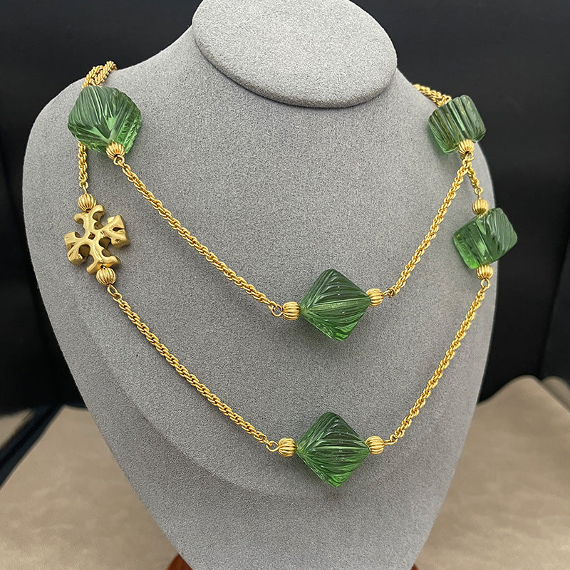 Flat lay of multiple pieces (e.g., earrings and a pendant) arranged on a neutral linen background, highlighting the contrast between tortoiseshell texture and gold metal.