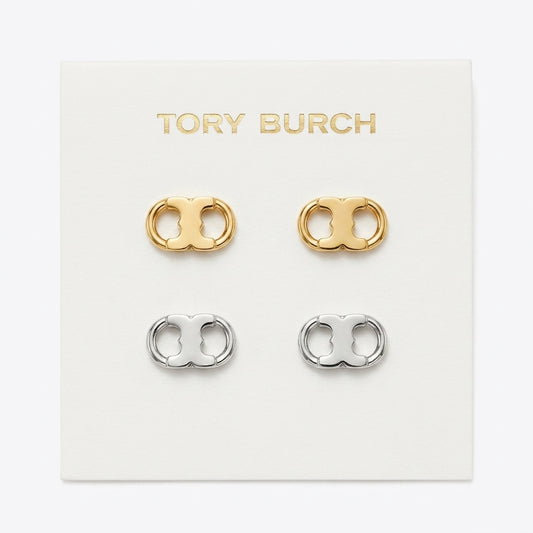 Tory Burch double-O stud earrings in gold and silver, displayed on a white branded card.