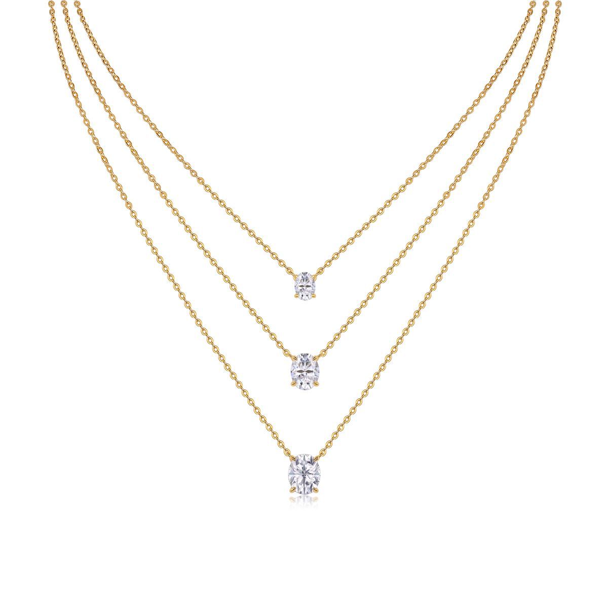 Clean white background — three oval moissanite pendants in graduated sizes, each on its own chain, layered elegantly on a bust form. The ovals catch light from multiple angles, showcasing the brilliant cut's signature sparkle.