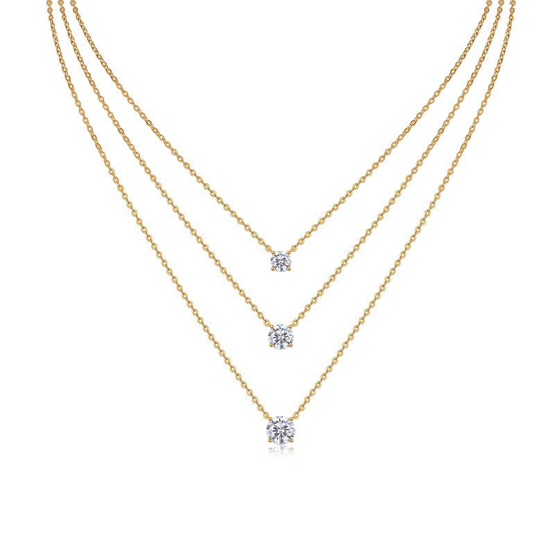 Clean white background — three oval moissanite pendants in graduated sizes, each on its own chain, layered elegantly on a bust form. The ovals catch light from multiple angles, showcasing the brilliant cut’s signature sparkle. 