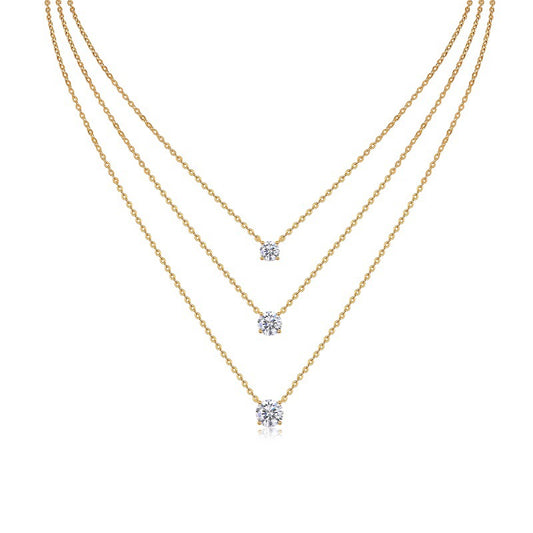 Clean white background — three oval moissanite pendants in graduated sizes, each on its own chain, layered elegantly on a bust form. The ovals catch light from multiple angles, showcasing the brilliant cut’s signature sparkle. 