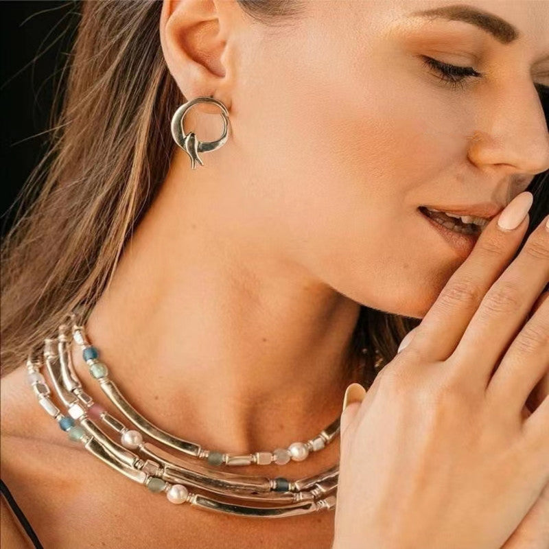 Earrings on deep blue or celestial background. Alt: “UNO de 50 Fly Me To The Moon Earrings – Silver Celestial Drops.”