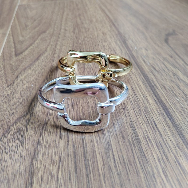 Goddess bracelet on neutral or ethereal background. Alt: “UNO de 50 Goddess Bracelet – Silver Sculptural Cuff.”