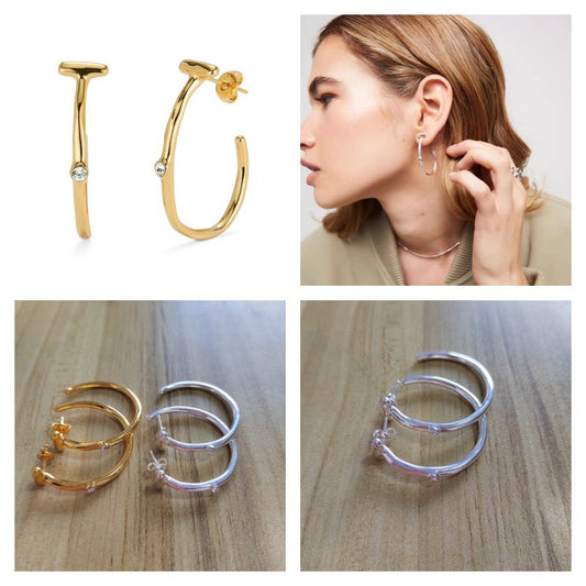 Hoop earrings on neutral or gemstone-inspired background. Alt: “UNO de 50 Hoop Earrings with White Topaz – Silver Crystal Hoops.”