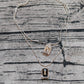 Multi-strand necklace displayed with crystals catching light. Alt: “UNO de 50 Multi-Strand Pendant Chain Necklace with Crystals.”