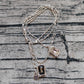 Multi-strand necklace displayed with crystals catching light. Alt: “UNO de 50 Multi-Strand Pendant Chain Necklace with Crystals.”