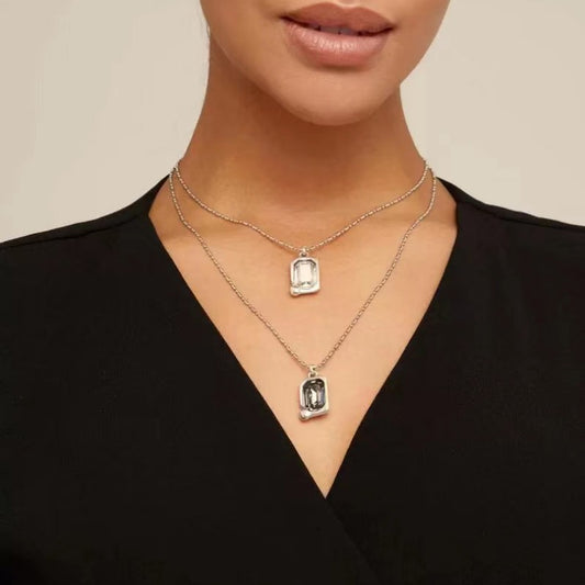 Necklace worn at full length. Alt: “Cascading Light: UNO de 50 Crystal Necklace.”