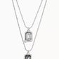 Multi-strand necklace displayed with crystals catching light. Alt: “UNO de 50 Multi-Strand Pendant Chain Necklace with Crystals.”