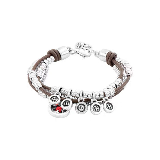 Silver bracelet on neutral background showing textured surface. Alt: “UNO de 50 Sterling Silver-Plated Bracelet – Textured Silver Cuff.”