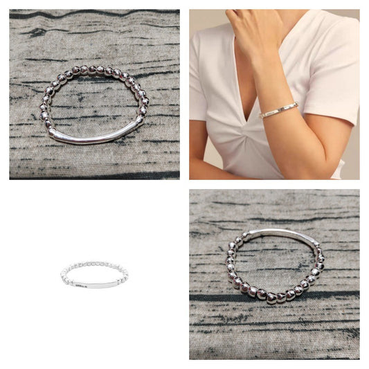 Beaded stretch bracelet on neutral background. Alt: “UNOde50 Beaded Stretch Bracelet – Silver Textured Beads.”