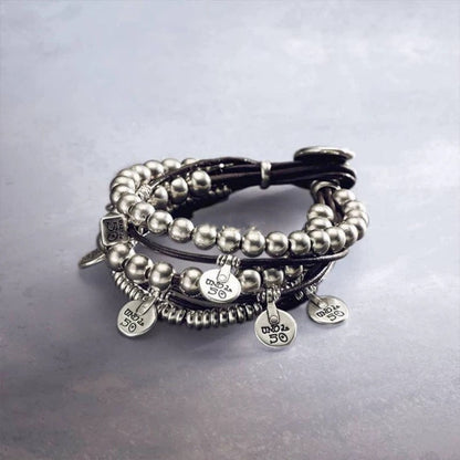 Wrap bracelet on neutral background showing leather and silver accents. Alt: “UNOde50 Bond Wrap Bracelet – Silver & Leather Wrap.”