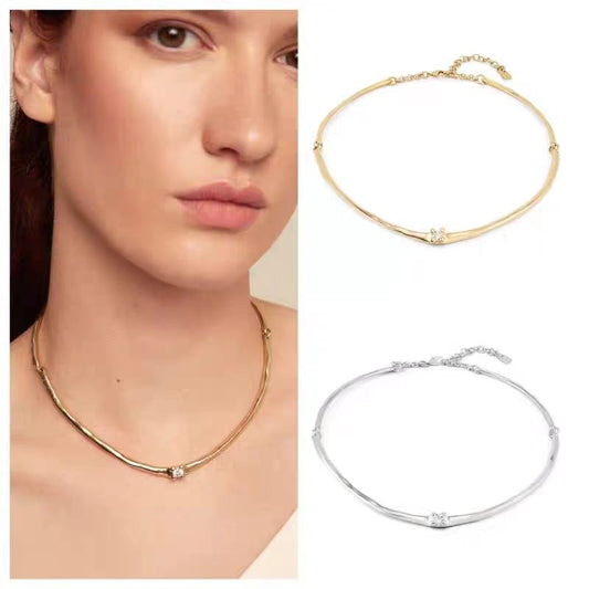  Choker on neutral or textured background. Alt: “UNOde50 Choker Necklace with White Cubic Zirconia.”