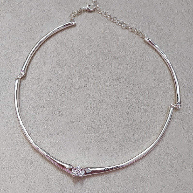  Choker on neutral or textured background. Alt: “UNOde50 Choker Necklace with White Cubic Zirconia.”