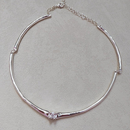  Choker on neutral or textured background. Alt: “UNOde50 Choker Necklace with White Cubic Zirconia.”