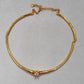  Choker on neutral or textured background. Alt: “UNOde50 Choker Necklace with White Cubic Zirconia.”