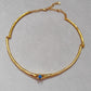  Choker on neutral or textured background. Alt: “UNOde50 Choker Necklace with White Cubic Zirconia.”