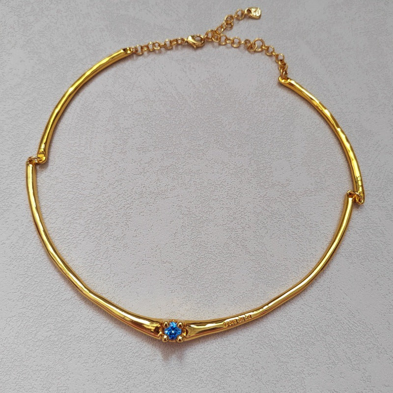  Choker on neutral or textured background. Alt: “UNOde50 Choker Necklace with White Cubic Zirconia.”