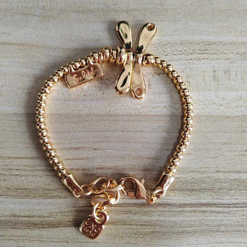 UNOde50 Elastic bracelet with 18K gold-plated dragonfly