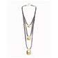 A multi-strand necklace featuring three layers of dark brown cord and three graduated gold-tone pendants, displayed against a plain white background.