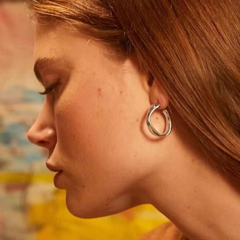  Earrings worn as mindful statement. Alt: “Sacred Form: UNOde50 Ohmmm Hoops.”