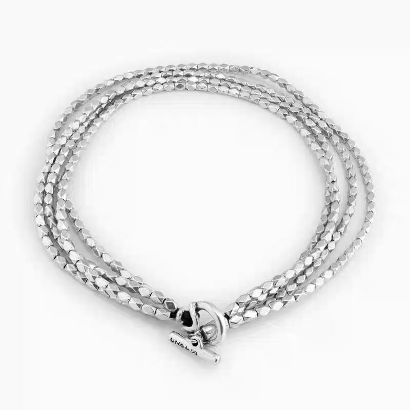 Necklace on neutral background. Alt: “UNOde50 Paths Necklace – Silver Layered Link Jewelry.”