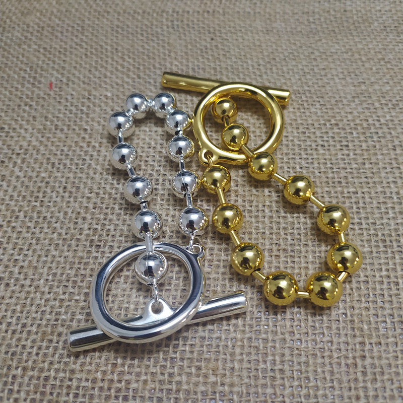 Gold snowflake bracelet on neutral or winter-inspired background. Alt: “UNOde50 Snowflake Bracelet Gold – Gold Snowflake Cuff.”