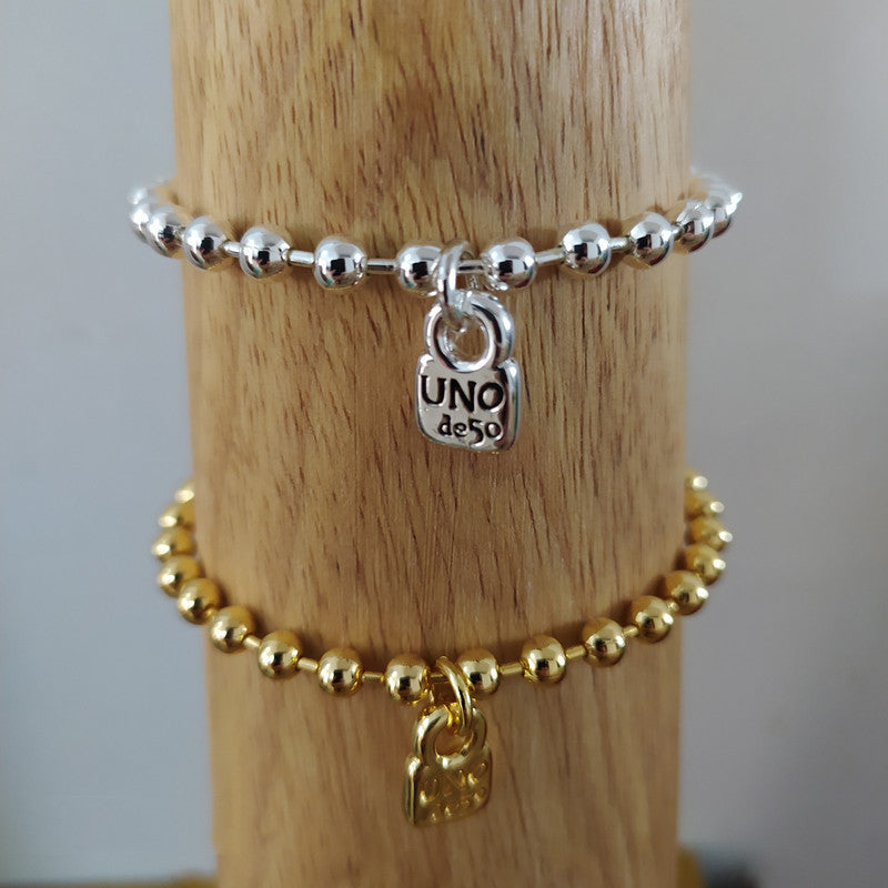 Gold snowflake bracelet on neutral or winter-inspired background. Alt: “UNOde50 Snowflake Bracelet Gold – Gold Snowflake Cuff.”