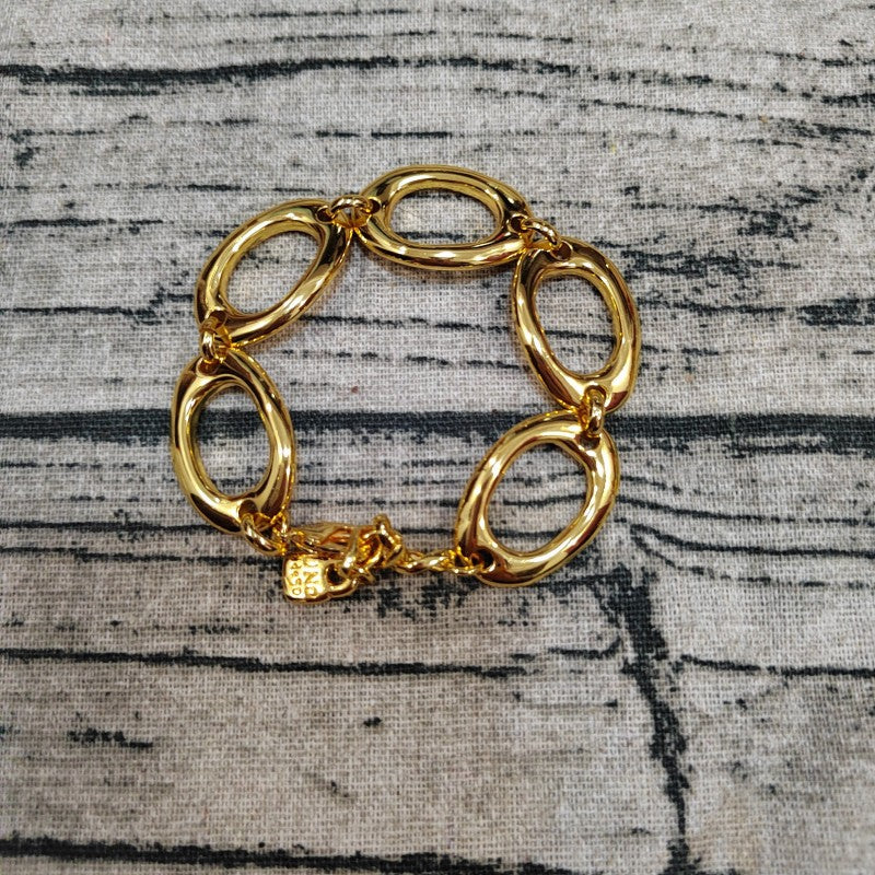  The One bracelet on neutral background showing sculptural form. Alt: “UNOde50 The One Bracelet – Silver Textured Cuff.”