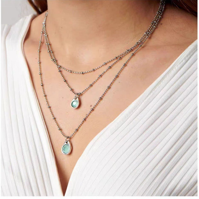 Necklace worn as bold statement. Alt: “Artistic Edge: Uno de 50 Crystal Pendant.”