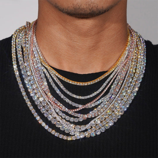 Multiple diamond necklaces on a person wearing a black shirt