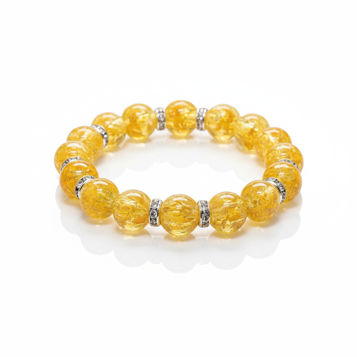 Yellow beaded bracelet with embedded stones on a white background