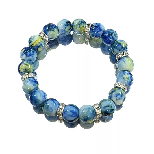 Blue marbled bead bracelet with silver accents on a white background