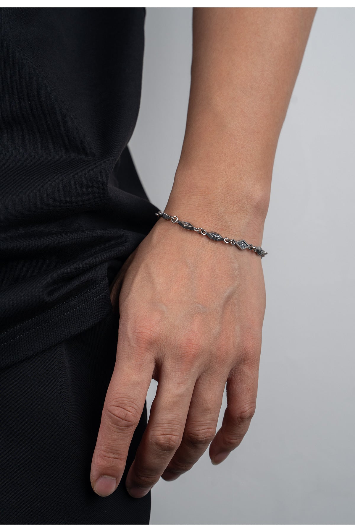 “Male model wearing vintage sterling silver bracelet”