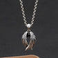Silver necklace with a unique pendant on a dark background