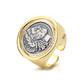 Gold ring with a silver emblem on a white background