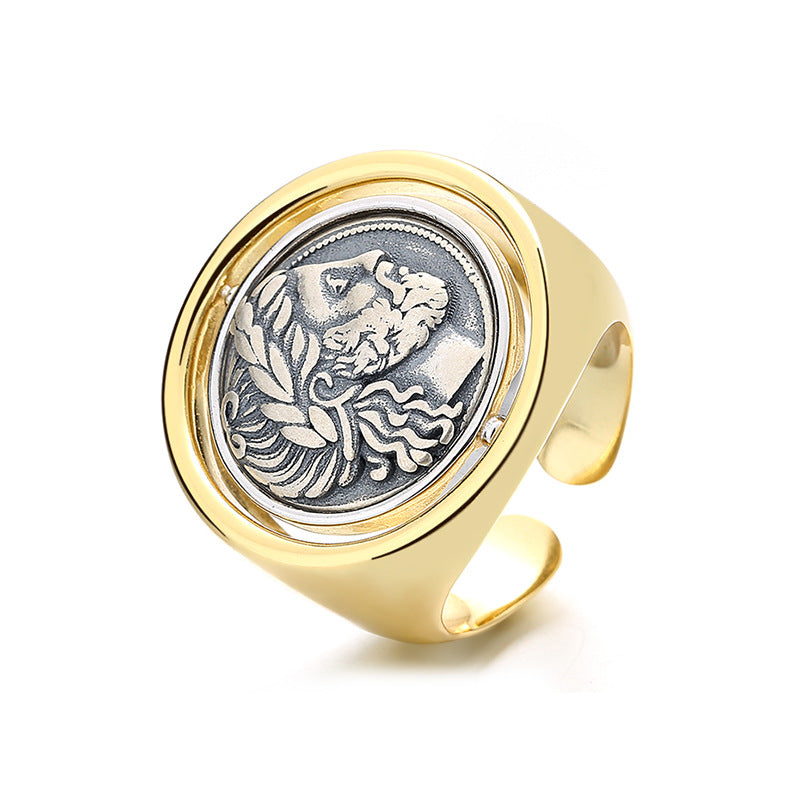 Gold ring with a silver emblem on a white background