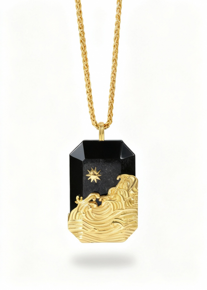 Wave PendantGold and black pendant necklace on a white background