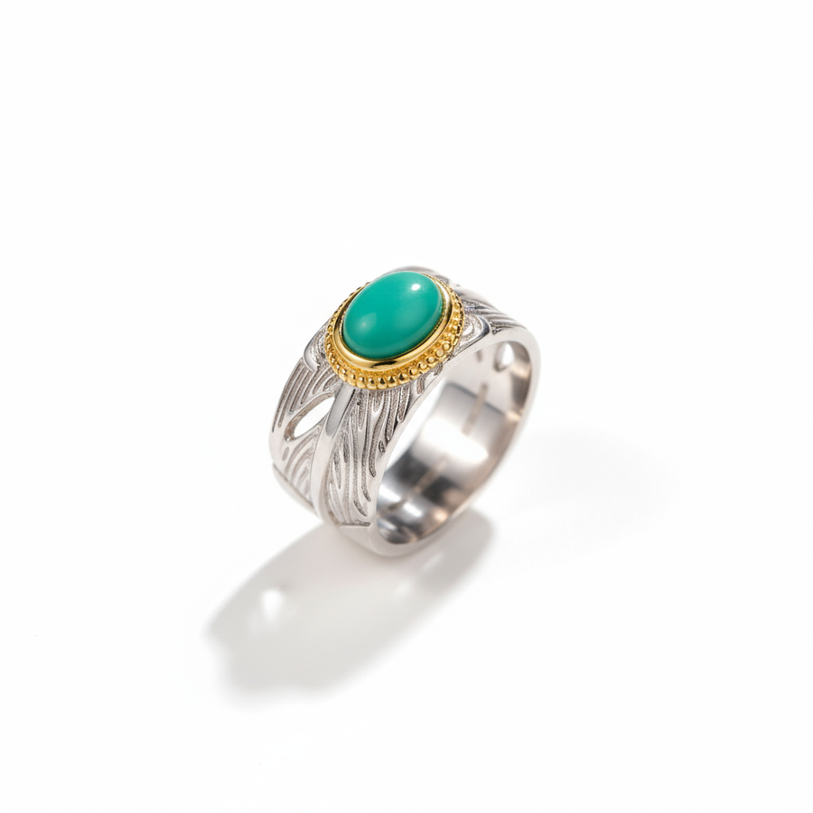 Silver ring with a green gemstone on a white background
