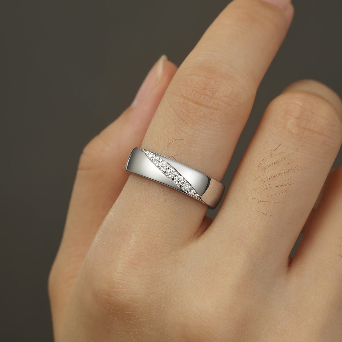 Bold flat lay featuring 4–5 wide-band rings on textured, unisex backdrop. Alt: “Wide-Band Moissanite Engagement Rings – Unisex Bold Collection.”