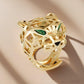 “Wild Grace” Leopard Head Ring | 18K Gold-Plated Sterling SilverGold panther head ring with green gemstones on a beige background