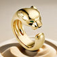 “Wild Grace” Leopard Head Ring | 18K Gold-Plated Sterling Silver Full Zircon Animal RingGold panther-shaped ring with a green gemstone on a beige background