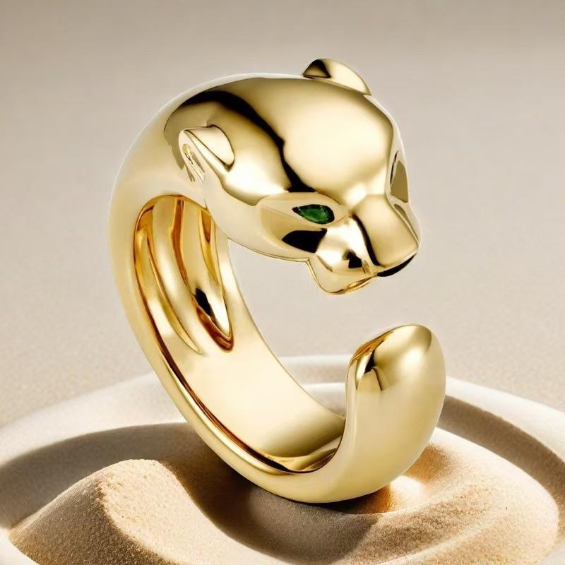 “Wild Grace” Leopard Head Ring | 18K Gold-Plated Sterling Silver Full Zircon Animal RingGold panther-shaped ring with a green gemstone on a beige background